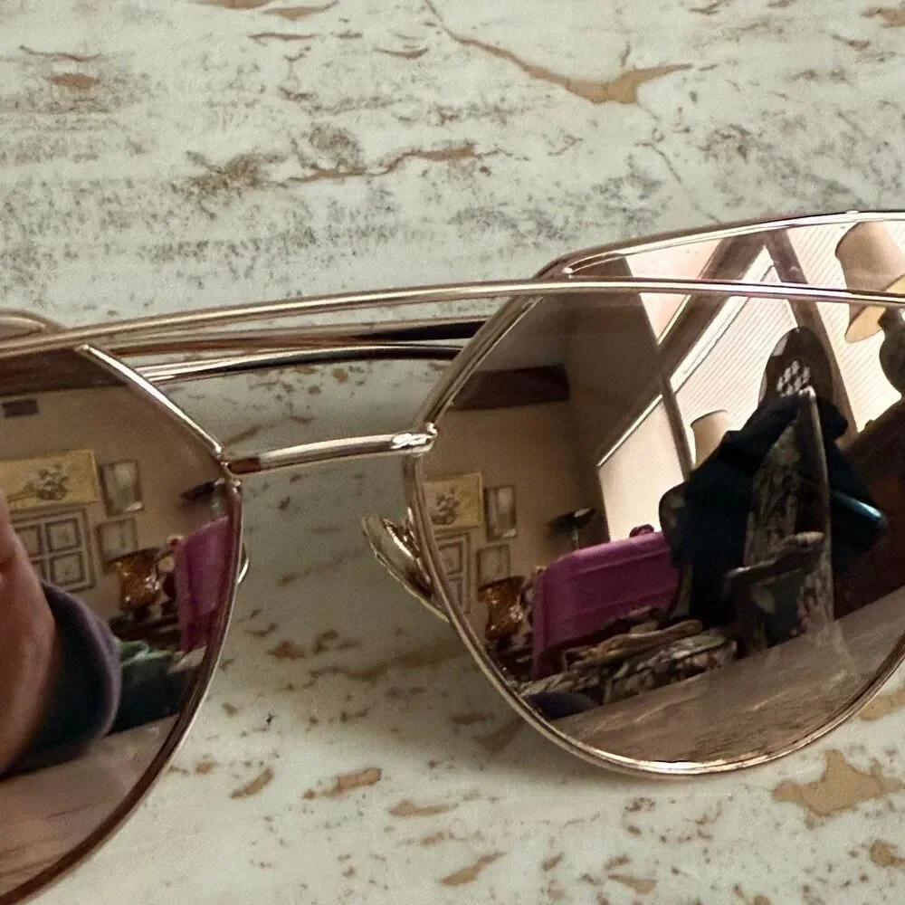 Rose gold wire frame cat eye aviator sunglasses with reflective pink lenses.
